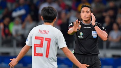 Venezuelan referee Jesus Valenzuela consults the VAR before disallowing a goal by Japan's Takefusa Kubo. AFP