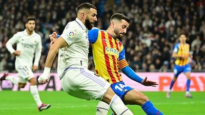Real Madrid's French forward Karim Benzema vies with Valencia's Spanish defender Jose Gaya. AFP