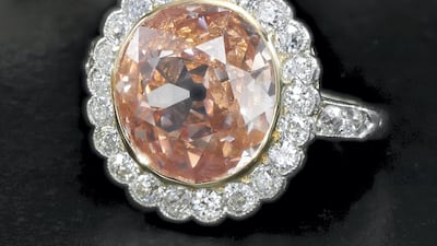 A diamond ring set with a 2.44-carat fancy orangy pink diamond, which sold for Dh2.1 million.