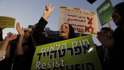 A woman shouts slogans as Arab Israelis and their supporters demonstrate during a rally to protest against the 'Jewish Nation-State Law' in the Israeli coastal city of Tel Aviv on August 11, 2018. - The controversial law passed last month declaring the country the nation state of the Jewish people. This has led to concerns that Arab Israelis, who account for some 17.5 percent of Israel's more than eight million population, could now be openly discriminated against in everything from housing to budgeting and land allocation. (Photo by Ahmad GHARABLI / AFP)