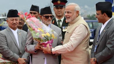 Nepalese prime minister Sushil Koirala, centre left, welcomes Indian prime minister Narendra Modi, on his arrival in Kathmandu. Prakash Mathema / AFP / August 3, 2014