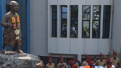 Security officers carry the body of India's acclaimed cartoonist RK Laxman past a statue of the ‘Common Man’ - a character he famously created - in Pune, India. Nitin Lawate/AP Photo