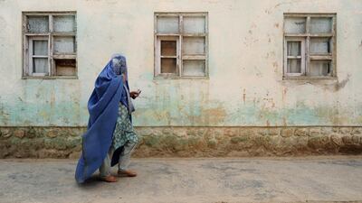 An Afghan resident arrives to cast her ballot at a polling station in Jalalabad. Polling stations across Afghanistan opened as Afghans headed to vote in the second-round election to choose a successor to Hamid Karzai. Noorullah Shirzada / AFP
