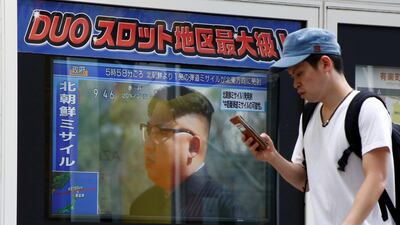 A man walks past a TV set showing North Korea's leader Kim Jong-Un in a news report about North Korea's missile launch in Tokyo, Japan, August 29, 2017. Kim Kyung-Hoon / Reuters
