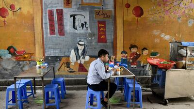 A man eats his lunch at a street side food stall in Hanoi. AFP