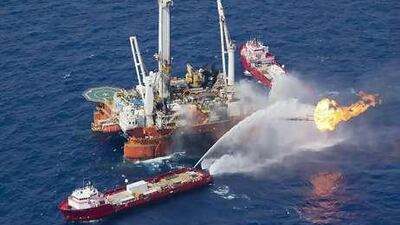 A vessel burns off crude from the Deepwater Horizon wellhead. The disaster casts uncertainty on the IEA forecast.