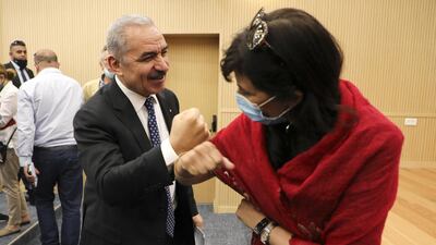Palestinian Prime Minister Mohammad Shtayyeh greets a journalist with an elbow bump following a meeting with members of the Foreign Press Association in Ramallah, in the Israeli-occupied West Bank. Reuters