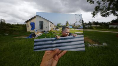 Resident Tyler Teal moves a metal sheet in the garden of his home on September 14, 2005.