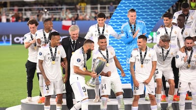 Players of Real Madrid look on as Karim Benzema walks the Uefa Super Cup trophy onto the stage during the trophy presentation. Getty Images