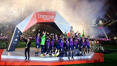 Barcelona's Sergio Busquets lifts the trophy after winning the Spanish Super Cup in Riyadh. Reuters