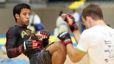 Hassan al Rumaithi, left, trains with Maiky Reiter at the Abu Dhabi Combat Club.