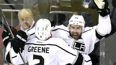 Los Angeles Kings' Jeff Carter, top right, celebrates with teammate Matt Greene after scoring the game-winning goal against the New Jersey Devils during the overtime period of Game 2 of the Stanley Cup finals.