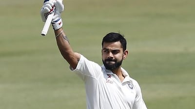 India captain Virat Kohli raises his bat to celebrate scoring double century during the second day of the one-off Test match against Bangladesh in Hyderabad on Friday. Aijaz Rahi / AP Photo