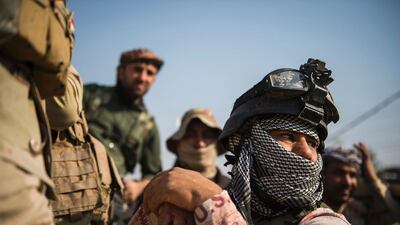 Soldiers from the Iraqi army 9th armoured division wait at base adjacent to the Al-Intissar neighbourhood of Mosul. Odd Andersen / AFP