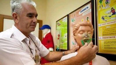 Abu Dhabi Aviation Safety Training Instructor Hank Jacobs demonstrates first aid techniques at Abu Dhabi Airport.