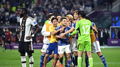 Japan players celebrate their win over Germany at the Khalifa International Stadium. Getty