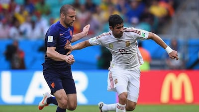 Diego Costa, right, of Spain holds off Ron Vlaar of the Netherlands during the 2014 FIFA World Cup Brazil Group B match between Spain and Netherlands at Arena Fonte Nova on June 13, 2014 in Salvador, Brazil. David Ramos/Getty Images