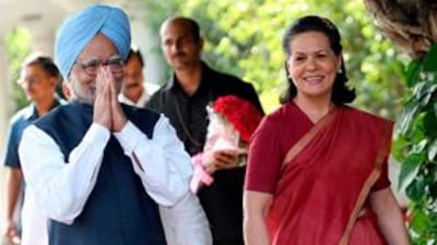 Prime Minister Manmohan Singh and the Congress Party president, Sonia Gandhi, arrive for a press conference at her residence in New Delhi.