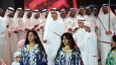 Lt General Sheikh Saif bin Zayed Al Nahyan, UAE Deputy Prime Minister and Minister of Interior, centre, dances during the 46th UAE National Day celebrations at Mushrif Palace. Seen with Sheikh Zayed bin Mohammed bin Hamad bin Tahnoon Al Nahyan, second right, and other dignitaries. Mohamed Al Hammadi / Crown Prince Court - Abu Dhabi