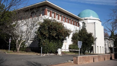 A gate to a parking lot is seen at the former Iranian Embassy in Washington, DC on November 14, 2025. In Washington's embassy district, years' worth of wildly overgrown vegetation outside an empty building was finally pruned away in September as the flag of Syria was raised. The symbolic reopening of the compound after 11 years of closure serves as a reminder that a number of buildings in the area of Washington called Kalorama are in a state of sad abandon, thanks to the violent jolts of world diplomacy. (Photo by ANDREW CABALLERO-REYNOLDS / AFP)