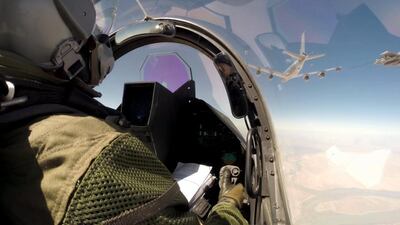 A photo provided by the French Army on September 19, 2014, shows a pilot navigating his Rafale fighter jet for a mid-air refuelling en route to Iraq. EPA