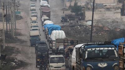 Trucks carry belongings of displaced Syrians in northern Idlib. Reuters