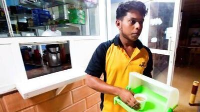 A server at Malik Al Karak Cafeteria is on his way to deliver tea to a customer in the early morning hours. Jaime Puebla / The National Newspaper