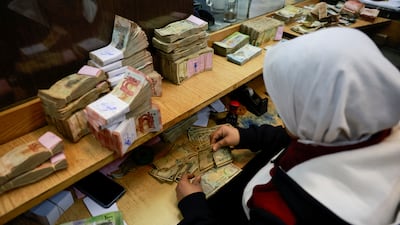 Counting money at Syria's central bank. Qatar's assistance to the new government in Damascus is not enough to pay a promised salary rise to government workers. Reuters