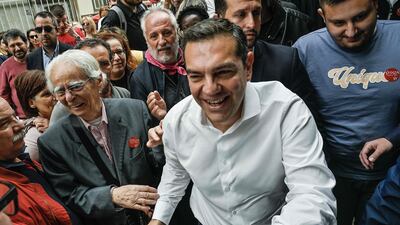 Leader of the leftist Syriza party Alexis Tsipras is greeted by supporters outside a polling station in Athens. AFP
