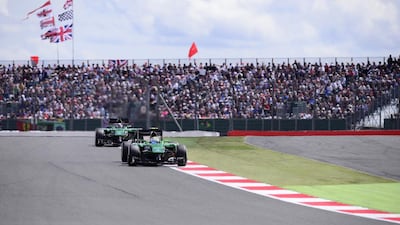 Caterham drivers Marcus Ericsson, left, and Kamui Kobayashi drive at the Silverstone circuit in Silverstone on July 6, 2014 during the British Formula One Grand Prix. AFP PHOTO / TOM GANDOLFINI