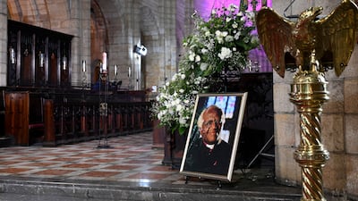 A portrait of of South African anti-apartheid campaigner Archbishop Desmond Tutu is displayed at St George’s Cathedral in Cape Town before a requiem Mass. Tutu died on December 26, 2021 at the age of 90, prompting tributes to a life spent fighting injustice. AFP
