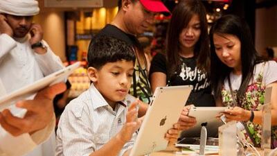 Youngsters check out the new iPad 2 at the Virgin MegaStore, Mall of the Emirates, in Dubai.