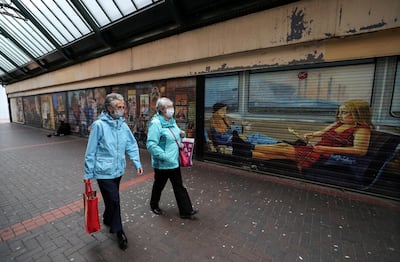 Women wearing face masks walk in Middlesbrough city centre in the UK, as heightened movement curbs attempt to contain the spread of the virus. Reuters