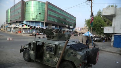 Afghan security officials take positions near the scene of a militant attack on prison in Jalalabad, Afghanistan. EPA