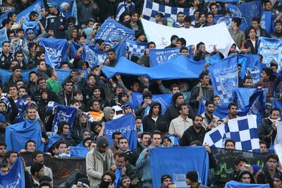Supporters of Iranian soccer team Esteghlal wave flags of their favourite team at the Azadi (Freedom) stadium, in Tehran, Iran. AP