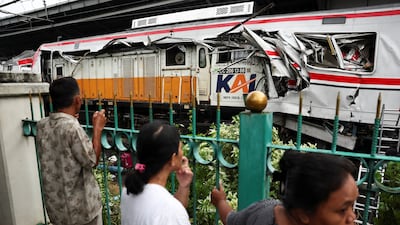 Authorities say a commuter train hit a taxi, then a long-distance train. Reuters