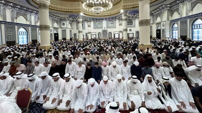 Worshippers perform Eid prayers at the mosque. Pawan Singh / The National