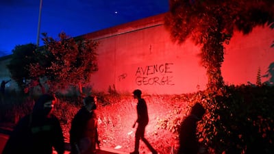 A man holds a flare as protesters enter Interstate 580, in Oakland California, to block traffic during demonstrations over the death of George Floyd, a black man who died after a white policeman knelt on his neck for several minutes. AFP