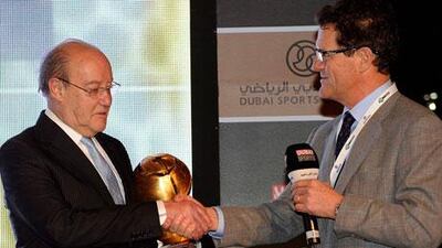 Aside from his critical comments about big-spending clubs 'stealing' youth players from small clubs, Fabio Capello, right, also took the time to present Pinto da Costa, president of Porto, with a career achievement trophy.