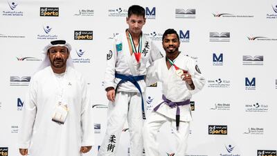 UAE's Hamad Eissa Al Balooshi, right, defeated Ildar Zainalov, centre, to win para jiu-jitsu gold in the JJIF World Championship at the Mubadala Arena on Tuesday. Courtesy UAEJJF