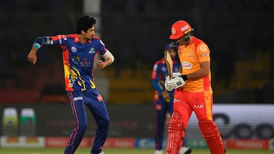 Karachi Kings bowler Umaid Asif, left, celebrates the wicket of Islamabad United's Rizwan Hussain during the Pakistan Super League T20 match at the National Cricket Stadium in Karachi. AFP