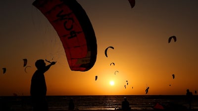 Israelis practise kitesurfing during sunset off the coast of Tel Aviv. AFP