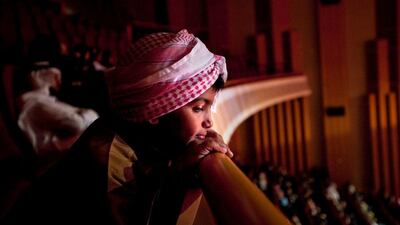 Audience members silently tune in as they listen to the performances during the Millions Poet competition at the Al Raha Theatre near Abu Dhabi. Silvia Razgova / The National