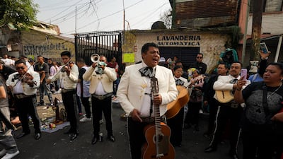 A mariachi group plays music outside the altar of Nuestra Senora de la Santa Muerte, or Our Lady of Holy Death, in Mexico City's Tepito neighborhood. La Santa Muerte is a folk saint, a personification of death, associated with healing, protection, and safe delivery to the afterlife by her devotees. AP Photo