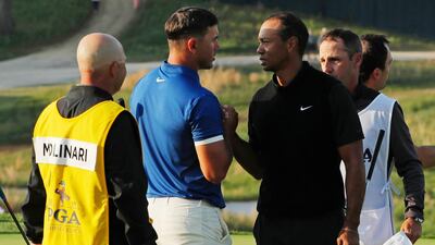 Brooks Koepka and Tiger Woods shake hands after finishing the second round of the PGA Championship on Friday. Andres Kudacki / AP Photo