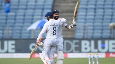 India's cricket team captain Virat Kohli, right, celebrates with teammate Ravindra Jadeja after scoring a double century. AFP