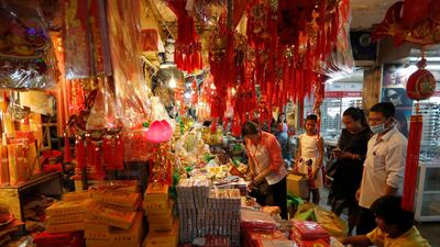 People in Phnom Penh, Cambodia, look at items for the upcoming Chinese New Year. EPA