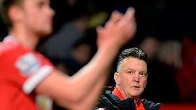 Manchester United manager Louis van Gaal, right, leaves at the end of the English Premier League football match against Burnley at Old Trafford in Manchester, north west England, on February 11, 2015. Manchester United won the game 3-1. AFP PHOTO / OLI SCARFF