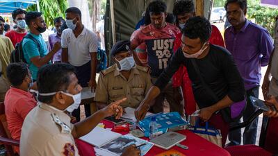 Relatives of train crash victims try to identify their bodies from photographs at the All India Institute of Medical Sciences hospital in Bhubaneswar, Odisha. AP