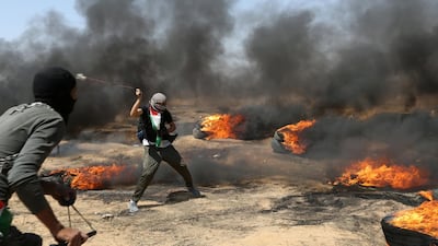 A demonstrator uses a sling to hurl stones at Israeli forces. Ibraheem Abu Mustafa / Reuters